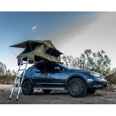 Car with a rooftop tent in a desert setting